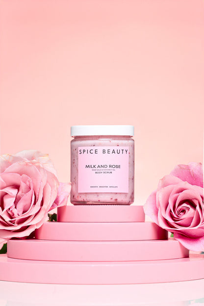 Milk and Rose body scrub jar with pink speckled scrub under a white lid