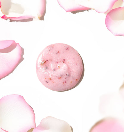 Pink bath bomb with small dark exfoliating specks