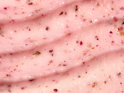 Pink body scrub texture with dark exfoliating particles