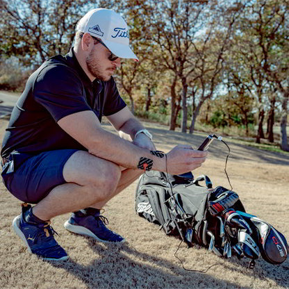 Muscle stimulator electrodes on leg with controller held in hand