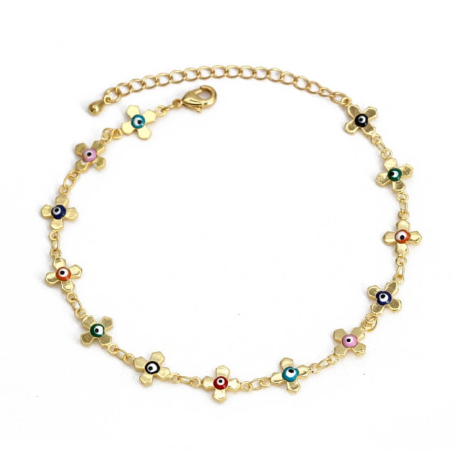 Gold charm bracelet with colorful eye and flower charms, small bead links and clasp