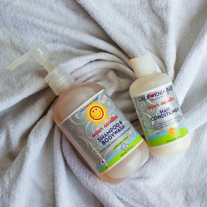 Super sensitive shampoo and conditioner bottles on soft towel