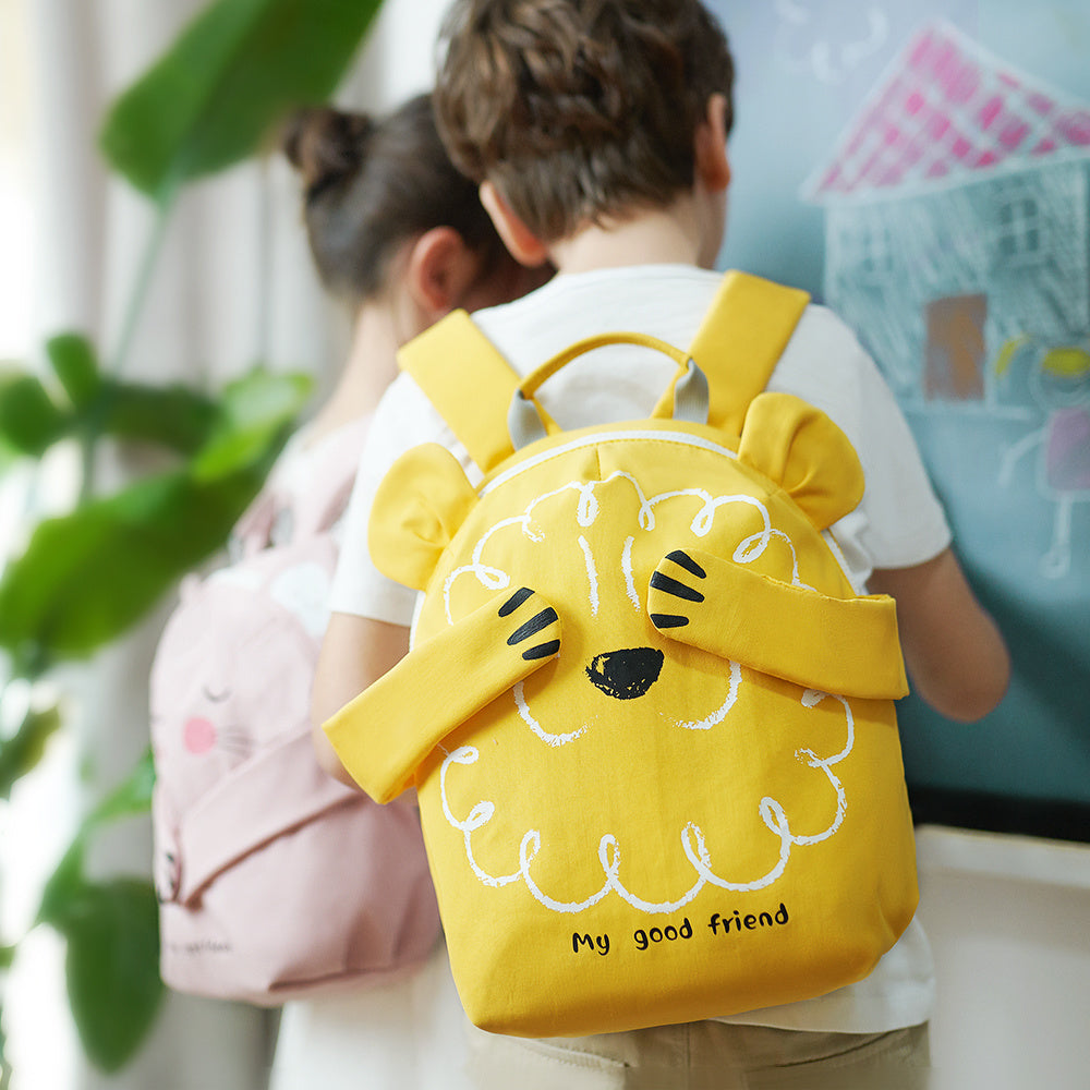 Children's yellow lion backpack worn by child from behind with adjustable shoulder straps