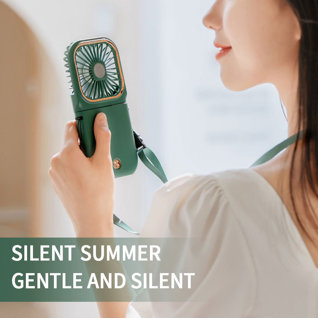 Mini cooling foldable fan in green being held in one hand