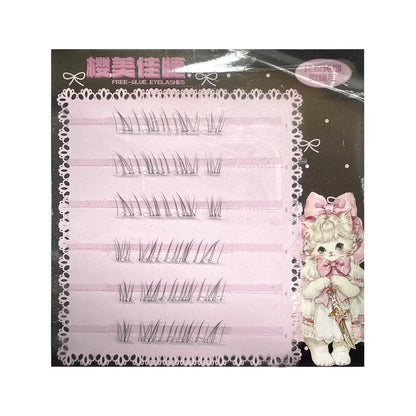 False eyelash cluster card with a pink gradient backing and printed cute cat character