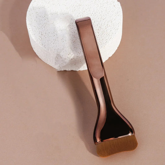 Curved foundation makeup brush, angled view, with brown bristles and glossy chocolate handle