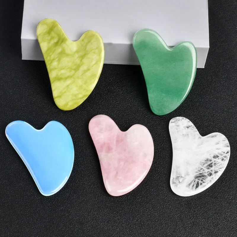 Facial gua sha stone set, assorted heart-shaped tools in light blue, pink, white, and green