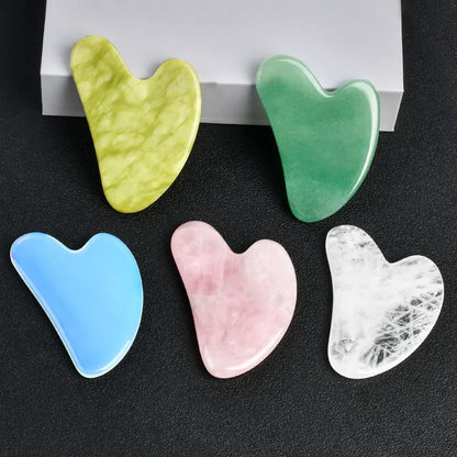 Facial gua sha stone set, assorted heart-shaped tools in light blue, pink, white, and green