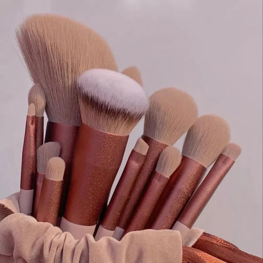 Makeup brush set with rose-gold and blush handles, soft beige brush heads
