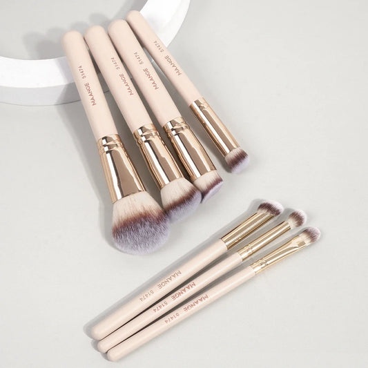 Apricot 7-piece makeup brush set, gold ferrules, soft gray bristles in angled layout