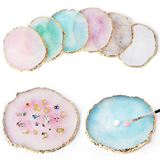 Set of round resin agate nail art palettes in pink, blue, white, and gray with gold rim.