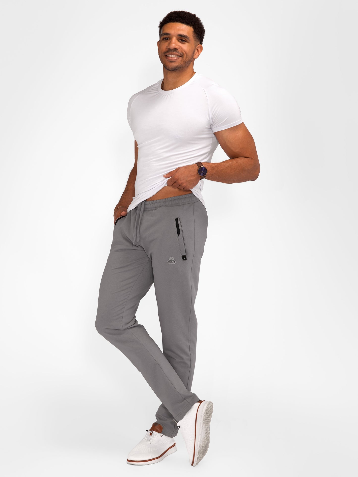 Dark grey tapered athletic sweatpants with drawstring waistband and side zip pocket