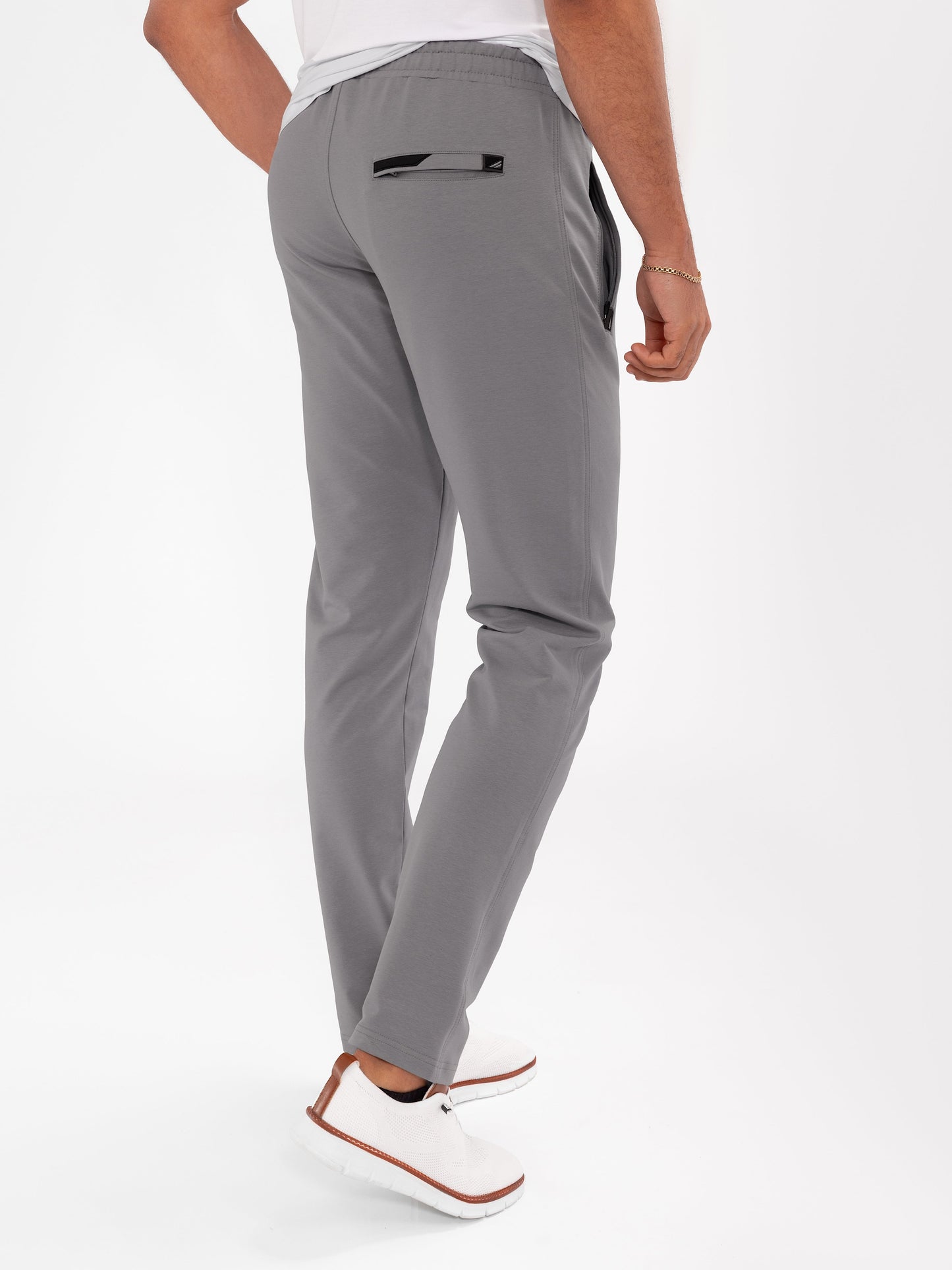 Dark grey tapered athletic sweatpants with elastic waistband, drawstring, and cuffed ankles