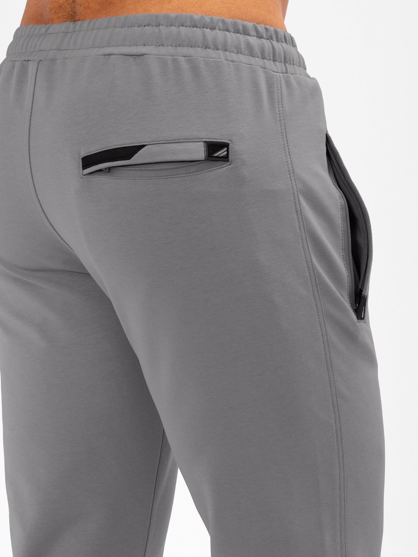 Dark grey athletic sweatpants back view with elastic waistband and tapered leg opening