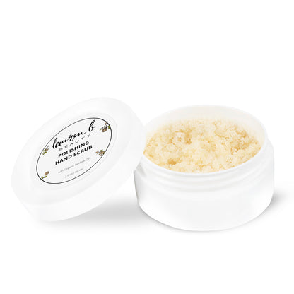 Open white jar of polishing hand scrub with pale beige granules