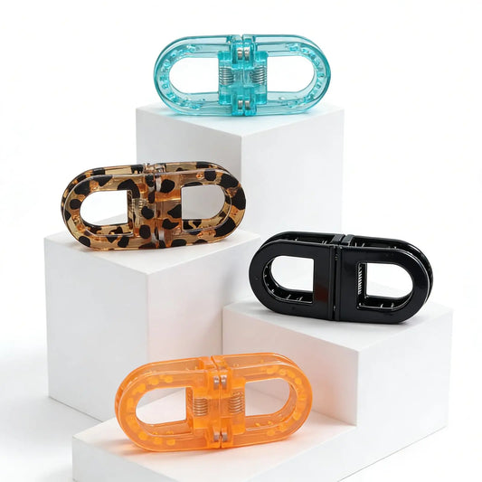 Magnetic hair clips set with clear turquoise, black, tortoise, and orange.