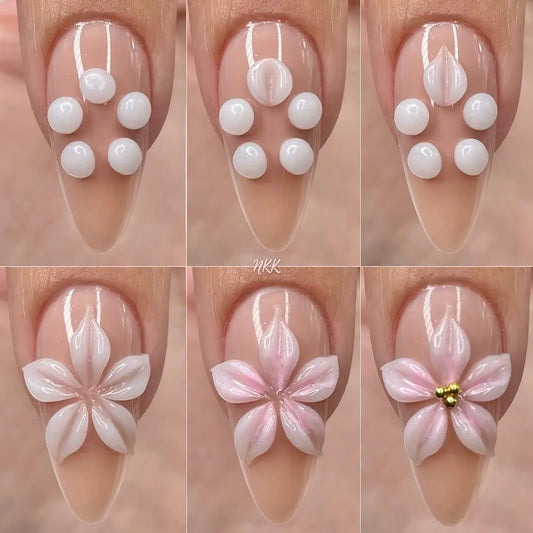White 3D flower nail gel art on nude tips with gold center accents
