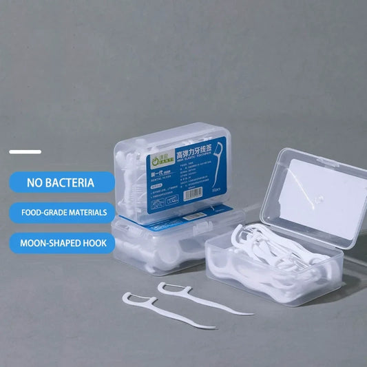 Dental floss picks and moon-shaped hooks in clear box with loose picks