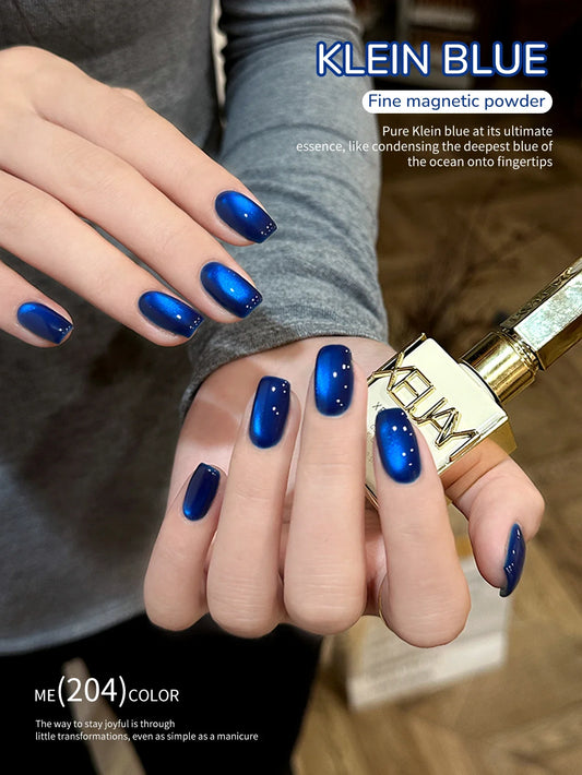 Blue cat-eye nail gel polish, glossy deep blue nails with light magnetic line