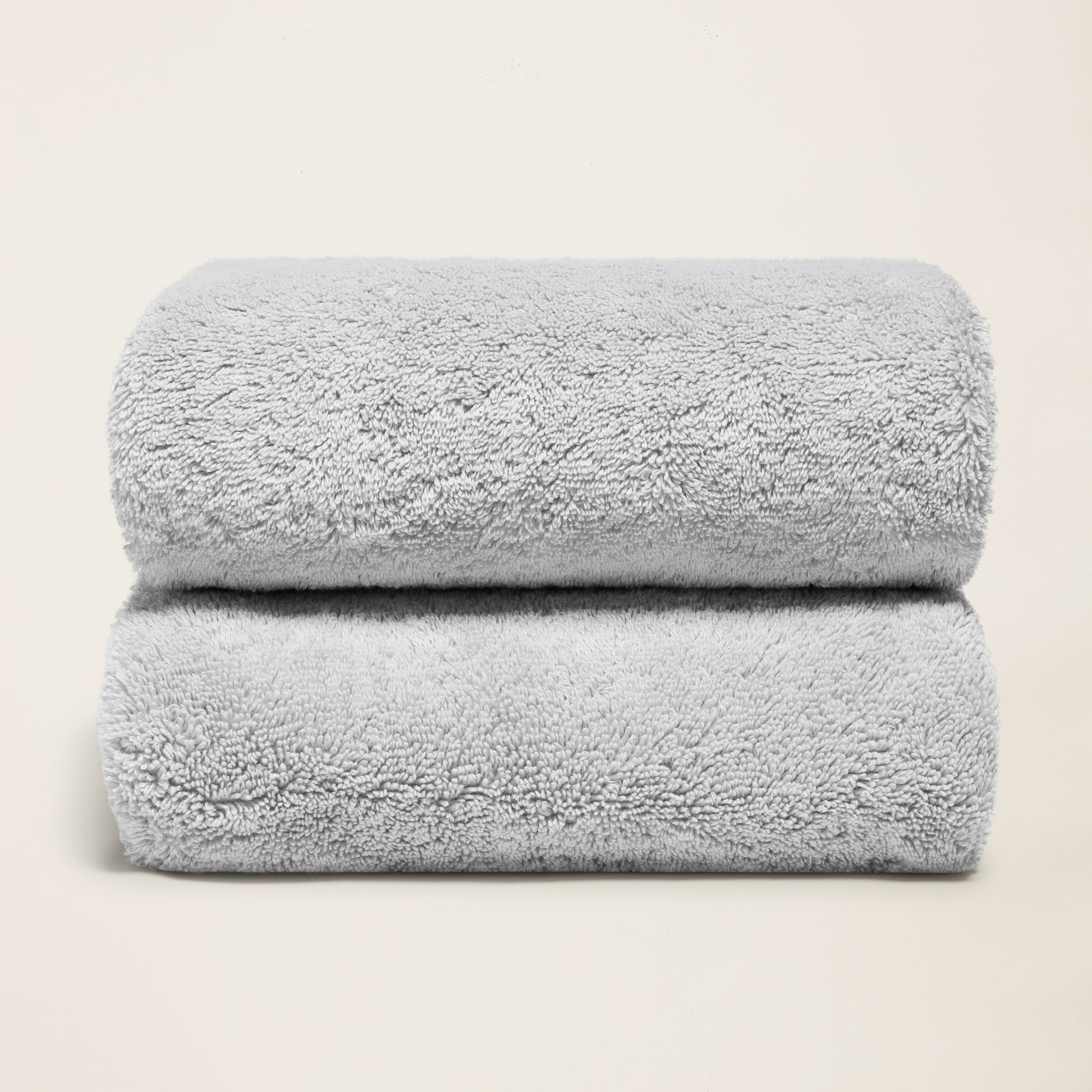 Light gray cotton towel set, plush folded towels with terry loop texture