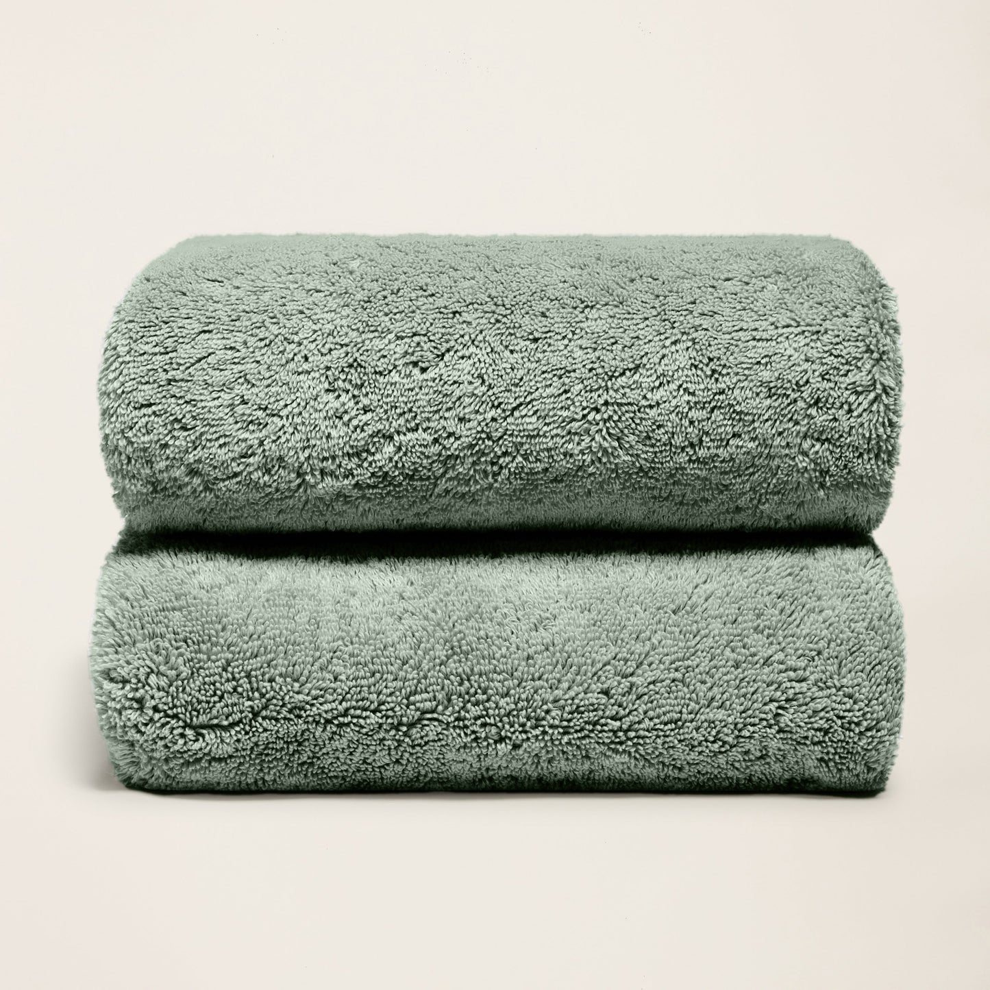 Plush cotton towels, deep sage green, two folded towels with thick pile