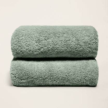 Plush cotton towels, deep sage green, two folded towels with thick pile