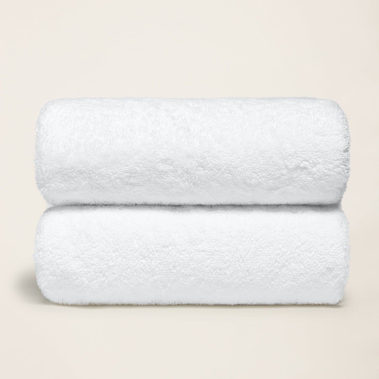 White cotton towel set, plush folded towels with thick terry loop texture