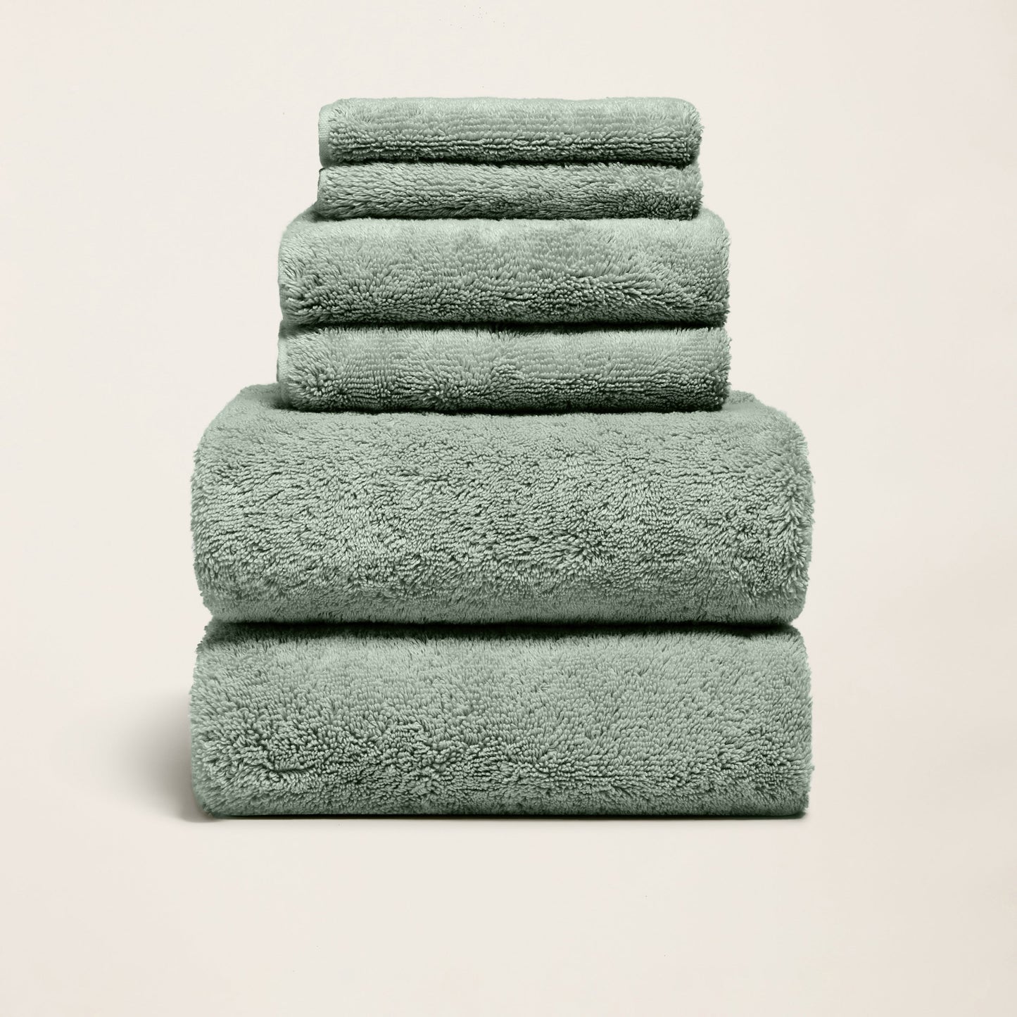 Plush cotton towels set, mint green, three folded towels stacked neatly