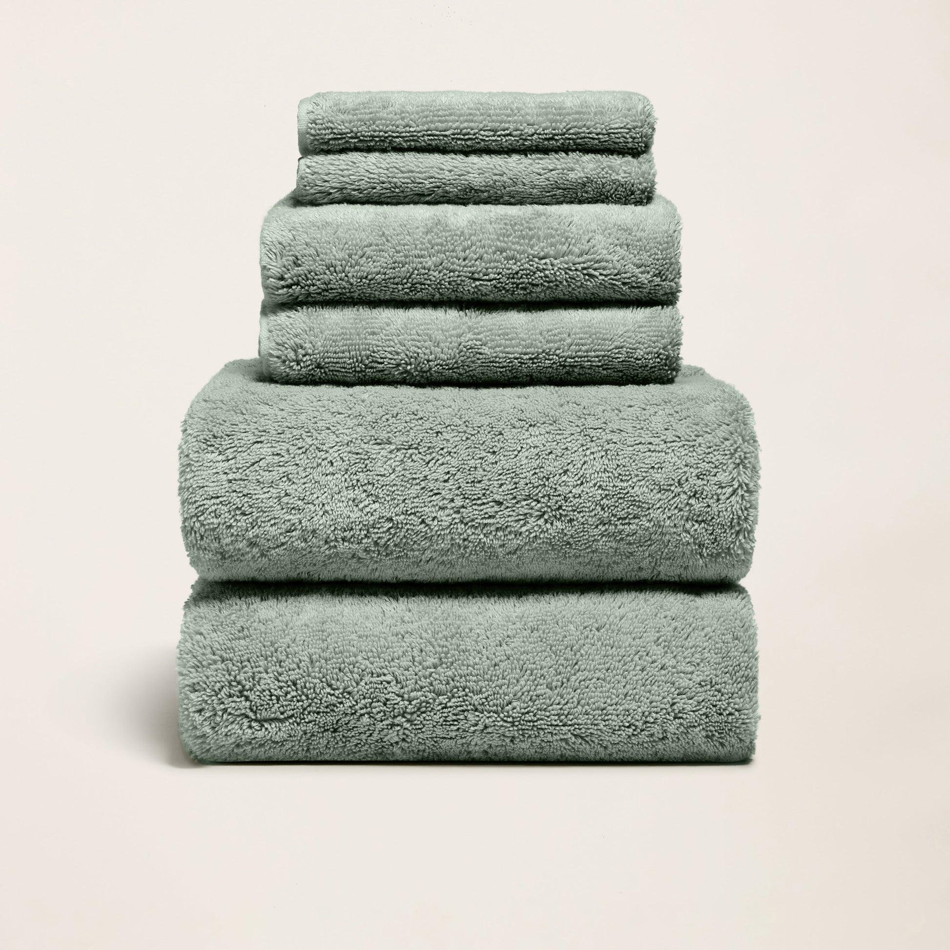 Plush cotton towels set, mint green, three folded towels stacked neatly