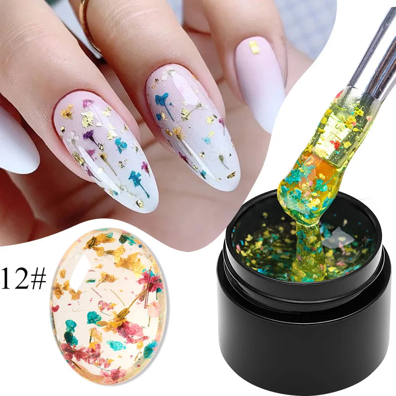 White gel nail polish with multicolor dried flowers on nails and gel bottle labeled 12