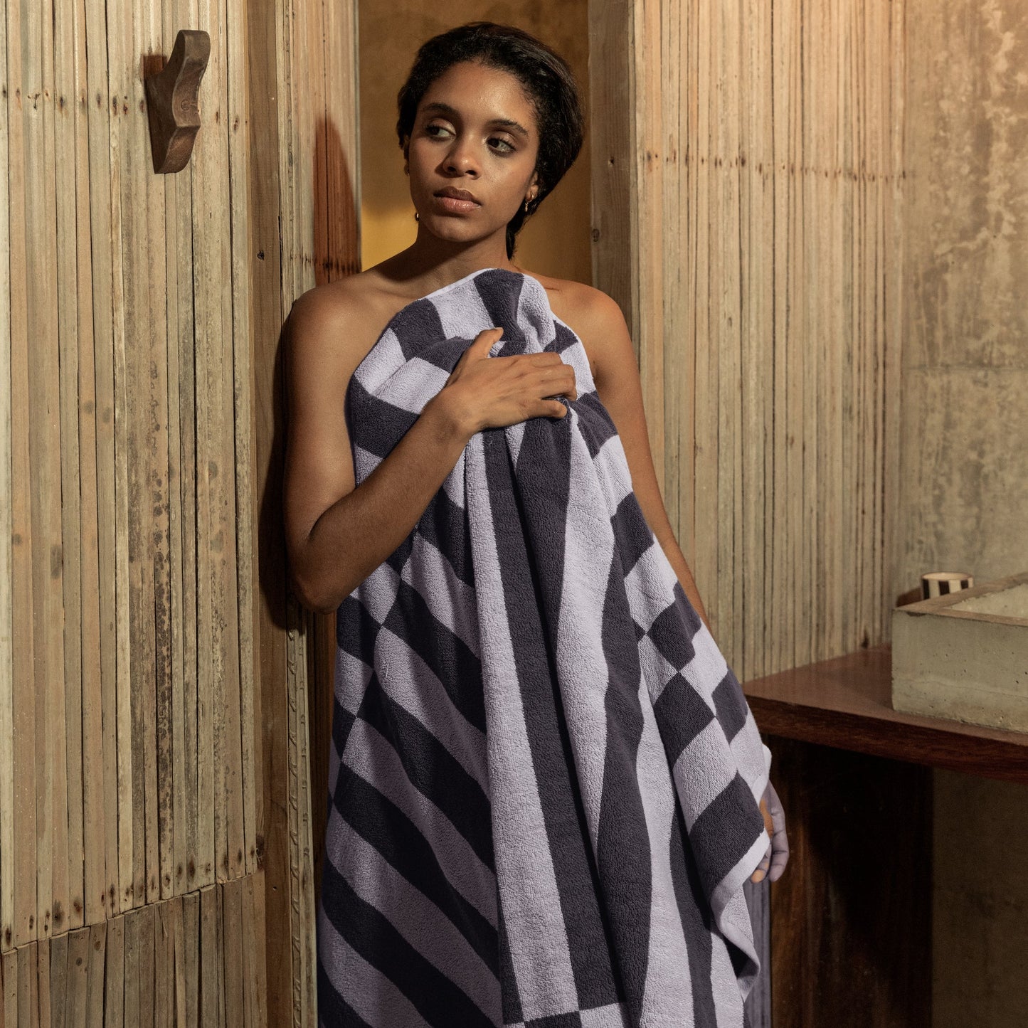 Cotton towel in lilac and charcoal with black-and-lilac wide check stripe pattern