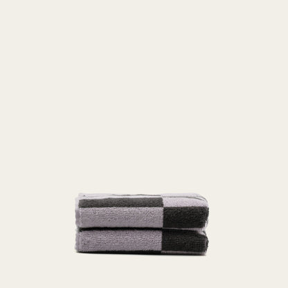 Rolled lilac and dark charcoal cotton towel with striped border