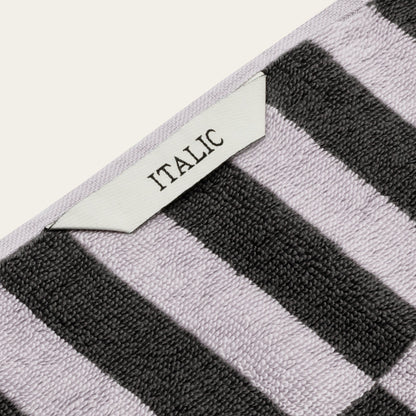 Australian cotton towel corner with lilac border and black-and-white stripe texture