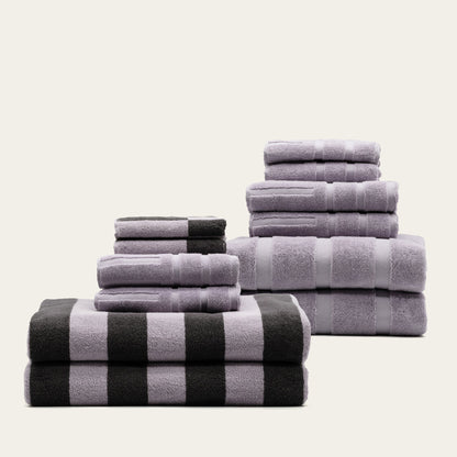 Stack of lilac and charcoal striped cotton towels, neatly folded