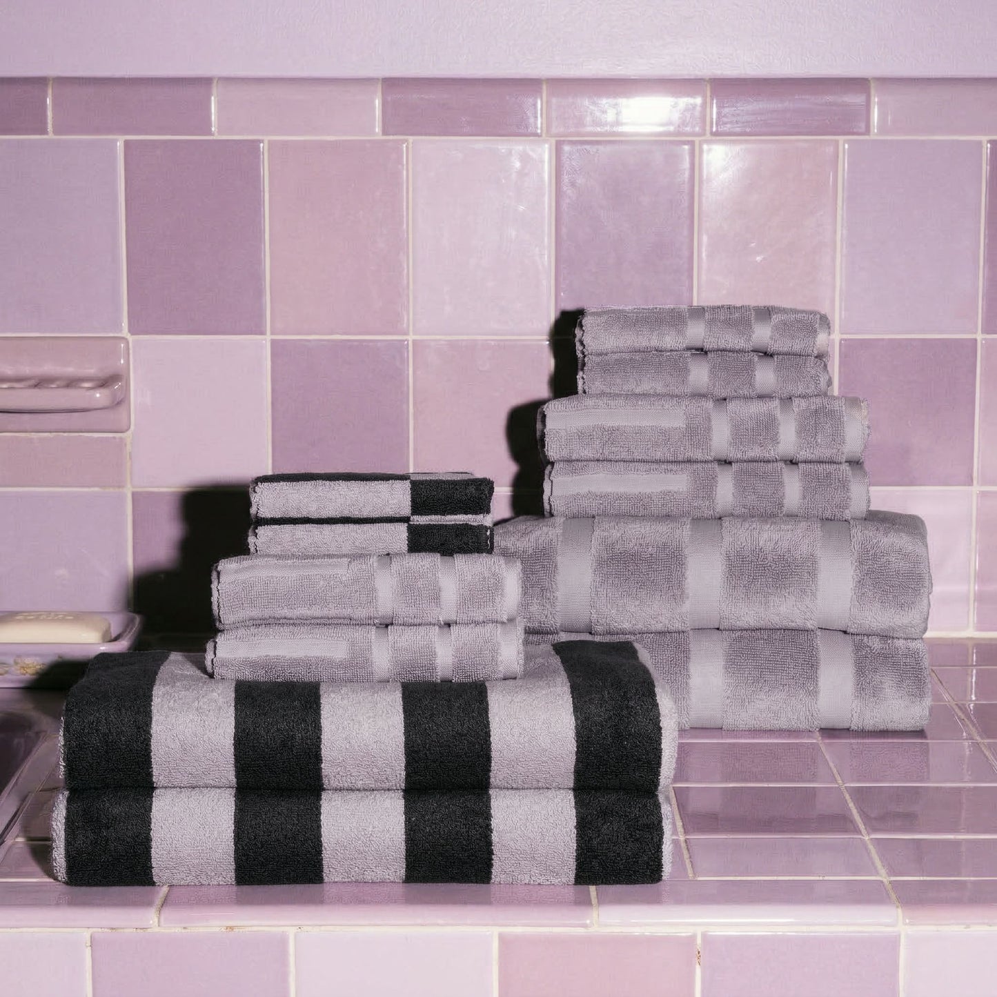 Australian cotton towels stacked in light gray-lilac and dark charcoal stripes