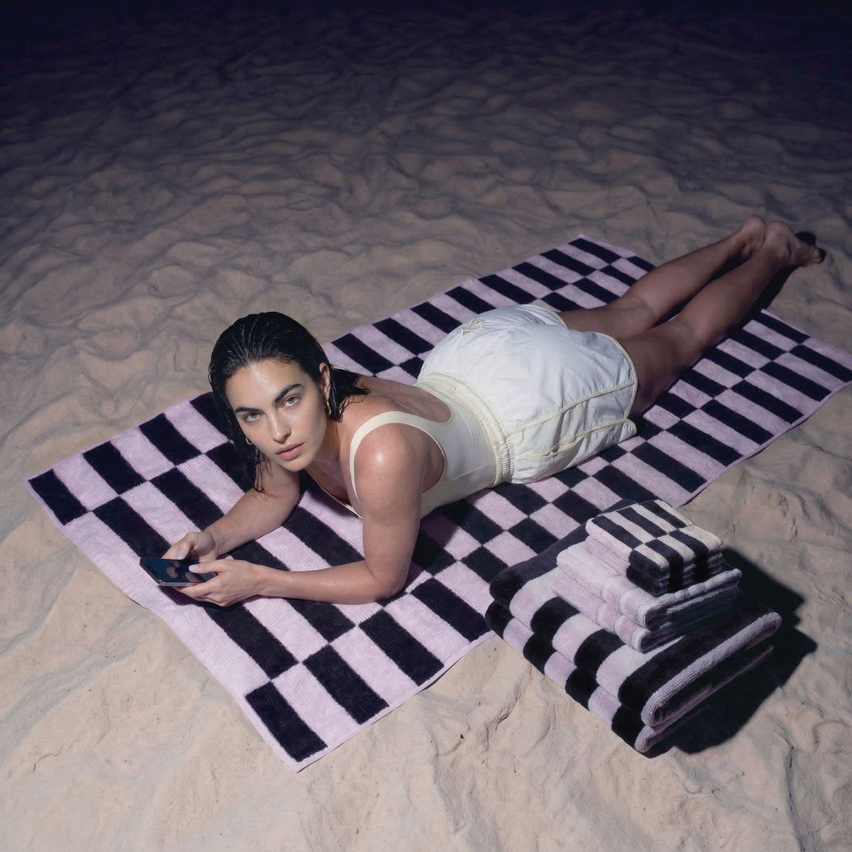 Cotton towels with black and white checkered stripes, neatly folded
