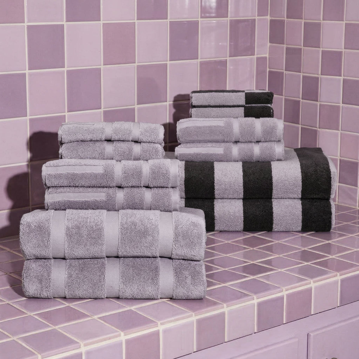 Lilac and light gray cotton towel stacks with neatly folded hand and bath towels