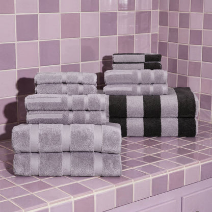 Lilac and light gray cotton towel stacks with neatly folded hand and bath towels