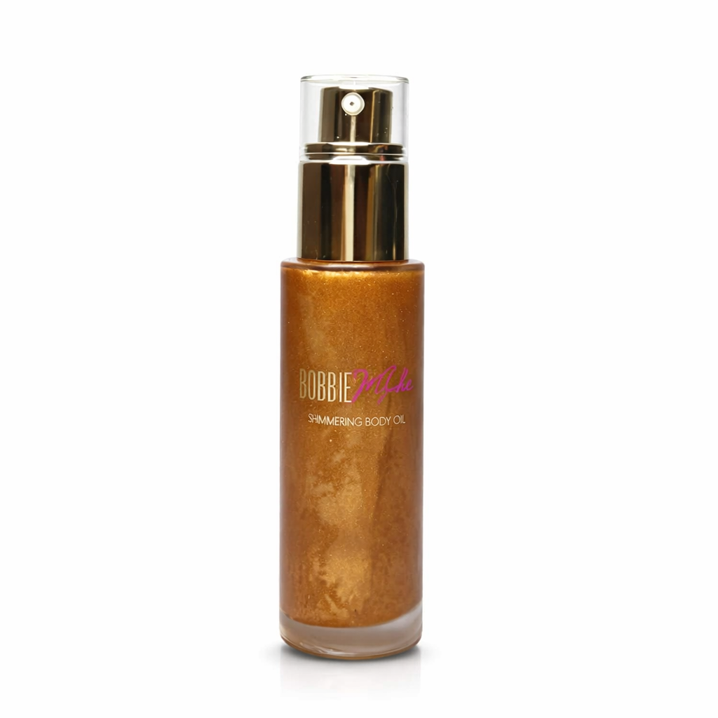 Shimmering body oil bottle with gold spray cap and amber-gold shimmer liquid