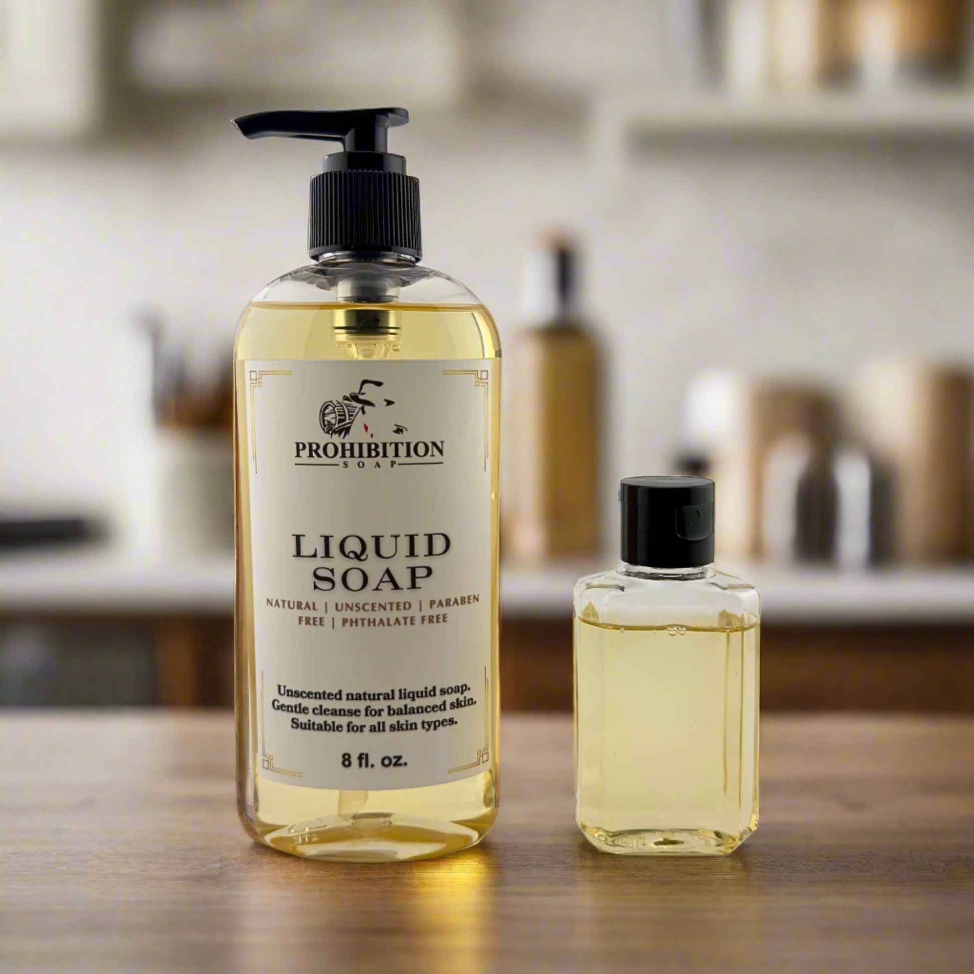 Liquid hand soap bottles with black pumps: large and small, clear yellow liquid