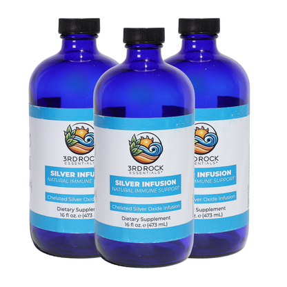 Three chelated silver infusion supplement bottles, blue glass with black caps