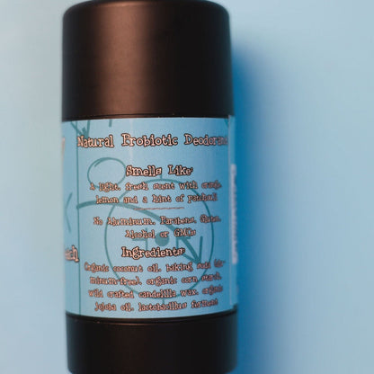 Natural probiotic deodorant stick bottle with black cap and ingredient information label.