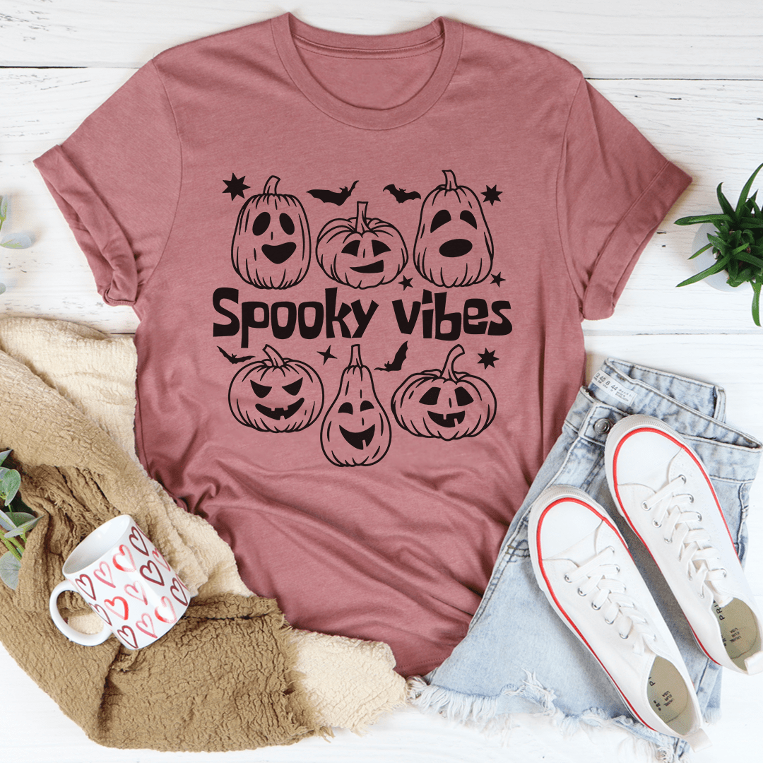 Mauve short-sleeve T-shirt with “Spooky Vibes” pumpkin faces graphic.