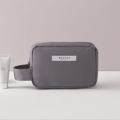 Gray cosmetic bag with side zipper pocket and adjustable strap