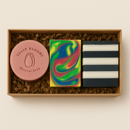 Soap gift box with round pink Tulip Blooms soap, rainbow bar, and black-striped bars
