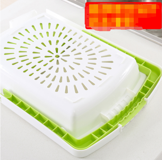 White and green plastic chopping board with perforated drying tray insert