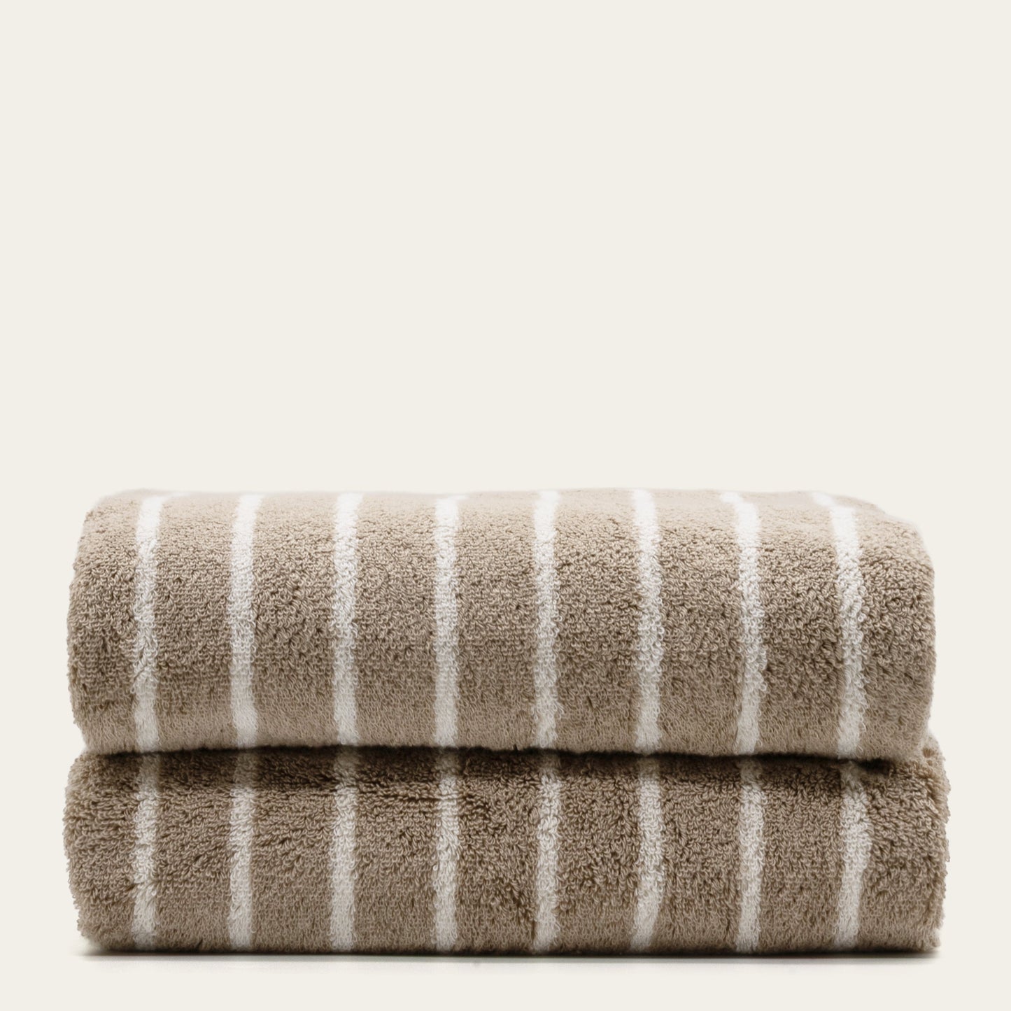 Striped cotton bath towels, stacked with taupe face and white vertical stripes