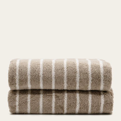 Striped cotton bath towels, stacked with taupe face and white vertical stripes