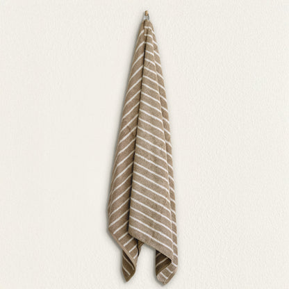 Striped cotton hand towel hanging, taupe and white stripe pattern on terry fabric