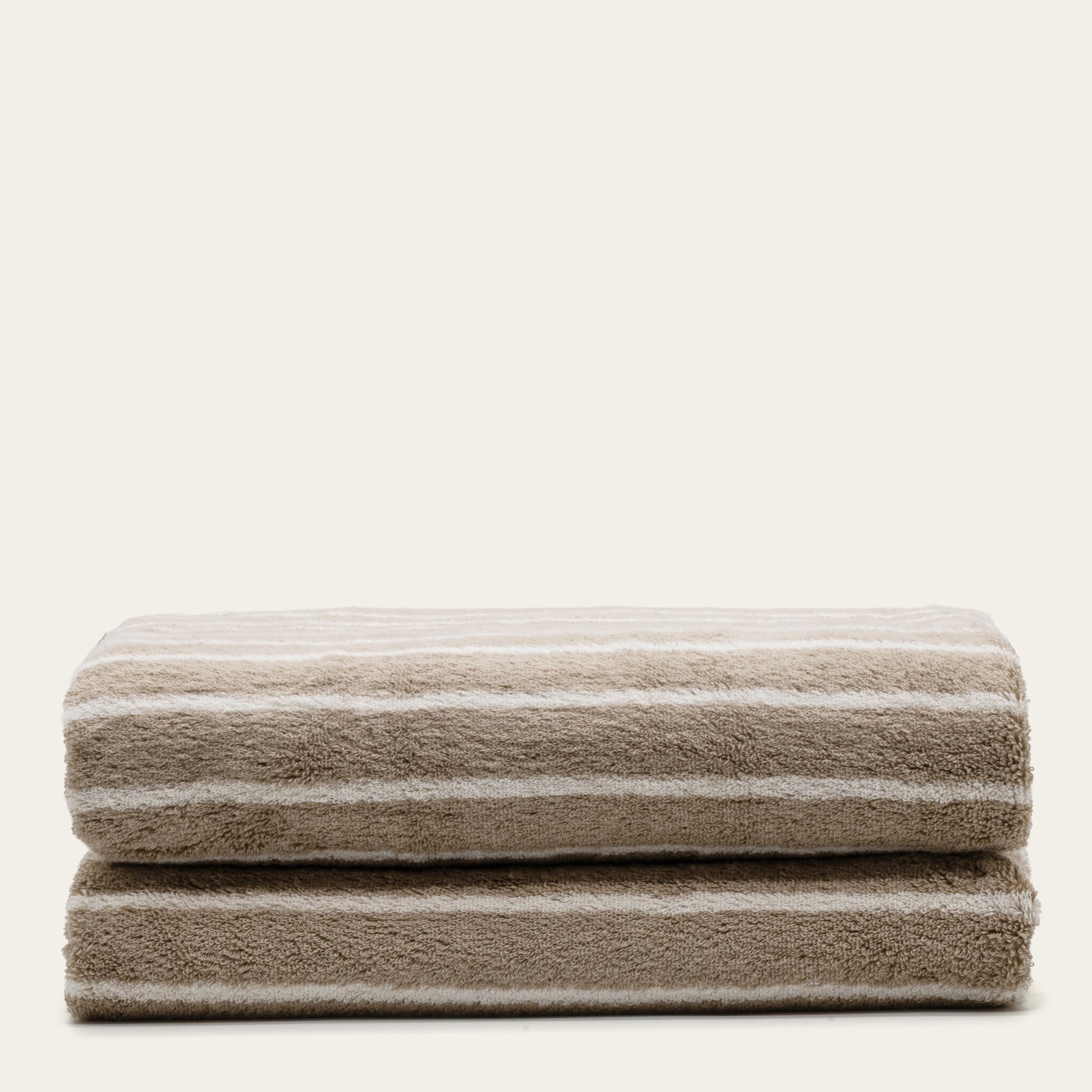 Striped cotton bath towels, folded stack with horizontal stripes in taupe and white